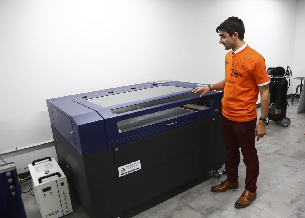 Matthew Viton, prototyping lab coordinator, shows a laser cutter during a tour of the lab at the grand debut of the completed Innovation Center and lab at AFWERX Vegas in Las Vegas on Tuesday, Jun ...