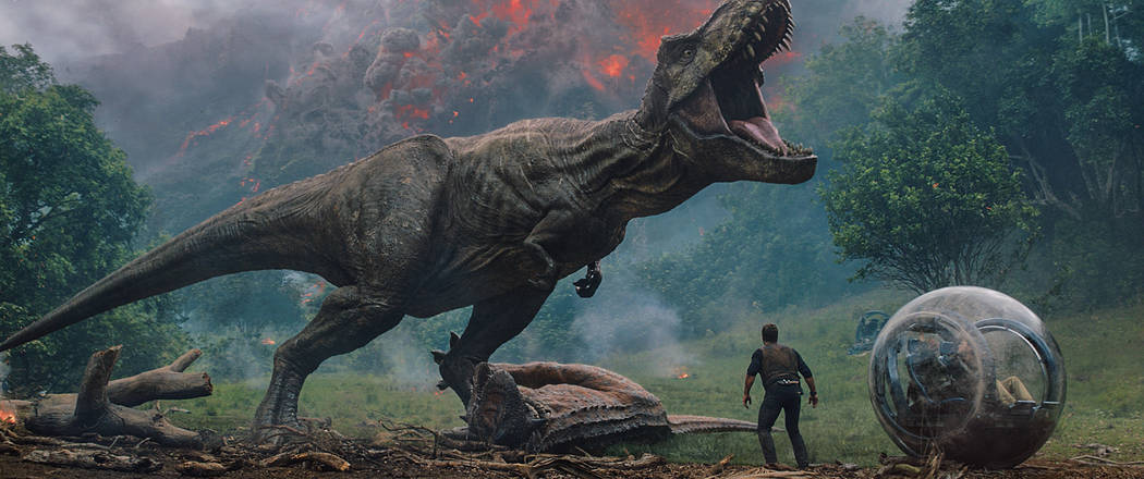 Owen (CHRIS PRATT) comes between the mighty T. rex and Claire (BRYCE DALLAS HOWARD) and Franklin (JUSTICE SMITH) in "Jurassic World: Fallen Kingdom." When the island's dormant volcano begins roar ...