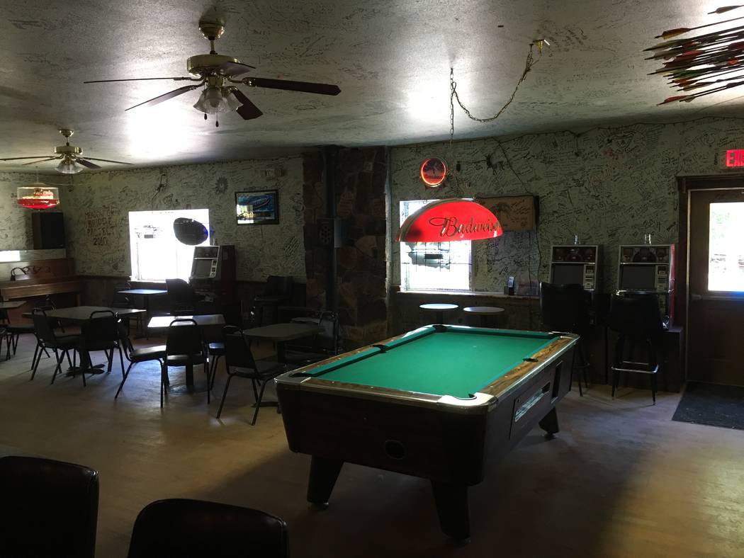 Two of the four quarter slot machines licensed Thursday, June 21, 2018, by the Nevada Gaming Commission are next to the pool table at the Outdoor Inn in Jarbidge, Nevada. (Courtesy of Jason Stegall)
