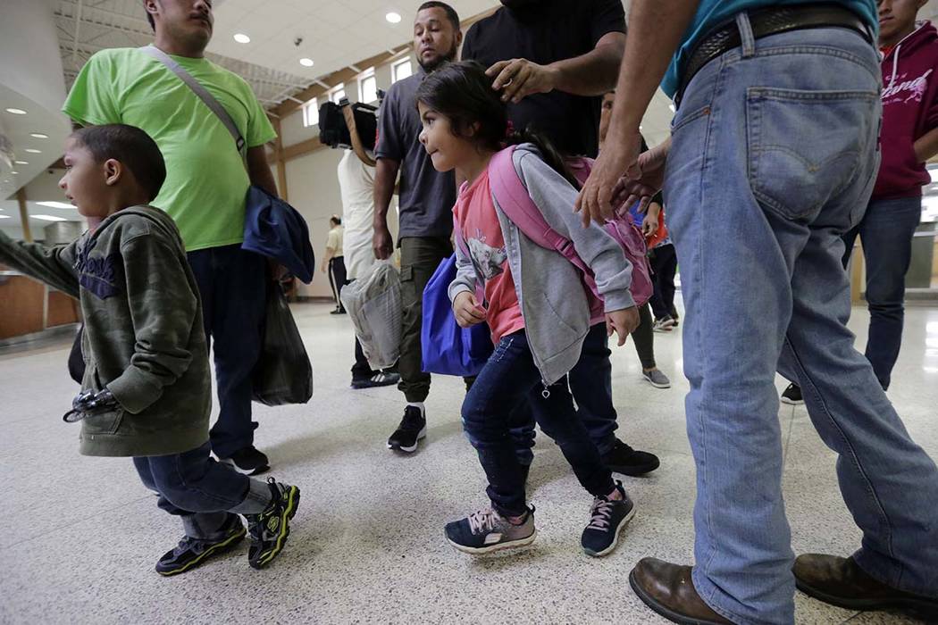 A group of immigrants from Honduras and Guatemala seeking asylum arrive at the bus station after they were processed and released by U.S. Customs and Border Protection, Thursday, June 21, 2018, in ...