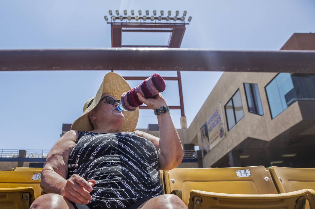 51s fan Kathy Mulligan stays hydrated during Las Vegas' home matchup with the Reno Aces in mid-day temperatures reaching 106 degrees on Sunday, June 24, 2018, at Cashman Field, in Las Vegas. Benja ...
