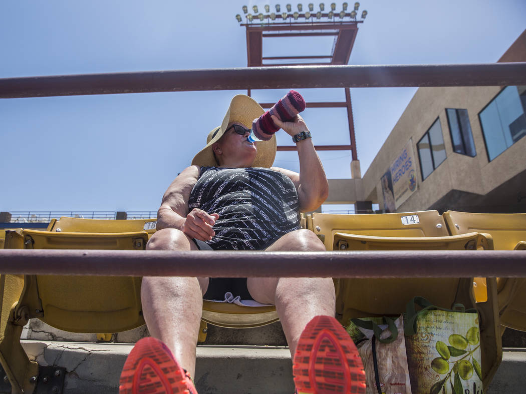 51s fan Kathy Mulligan stays hydrated during Las Vegas' home matchup with the Reno Aces in mid-day temperatures reaching 106 degrees on Sunday, June 24, 2018, at Cashman Field, in Las Vegas. Benja ...