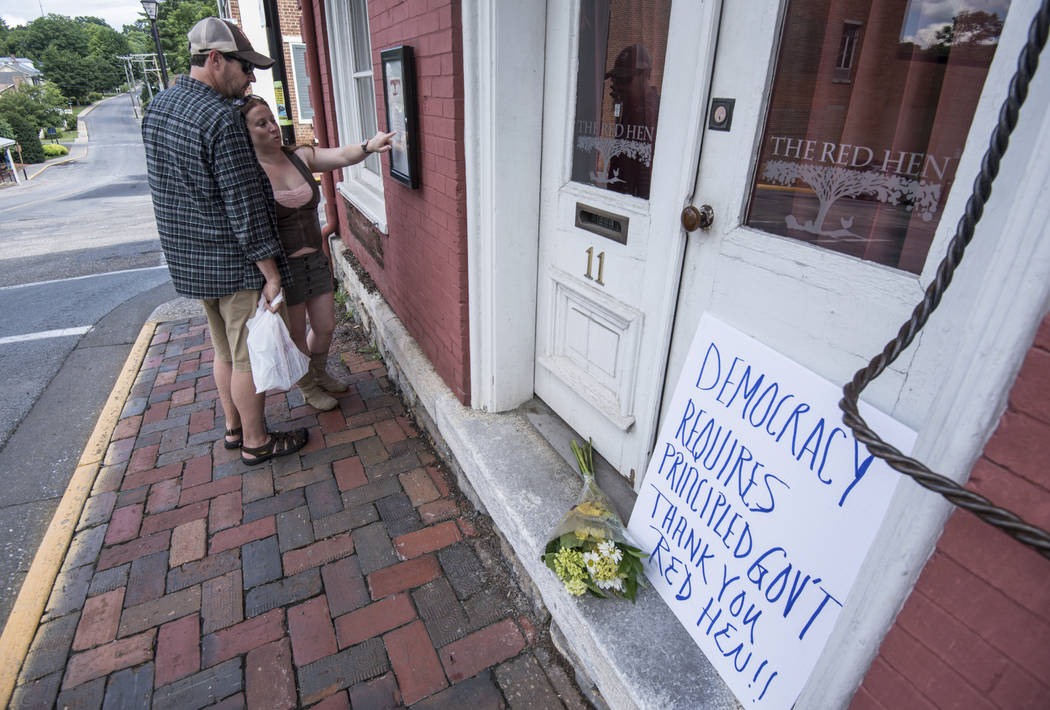 Passersby examine the menu at the Red Hen Restaurant Saturday, June 23, 2018, in Lexington, Va. White House press secretary Sarah Huckabee Sanders said Saturday in a tweet that she was booted from ...