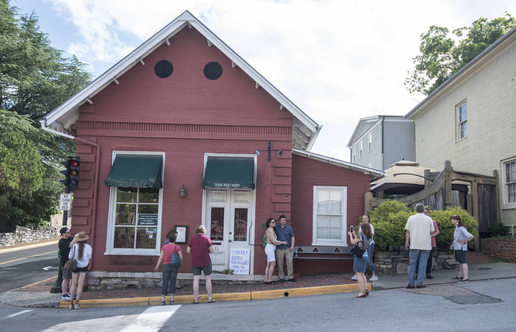 Passersby gather to take photos in front of the Red Hen Restaurant, Saturday, June 23, 2018, in Lexington, Va. White House press secretary Sarah Huckabee Sanders said Saturday in a tweet that she ...