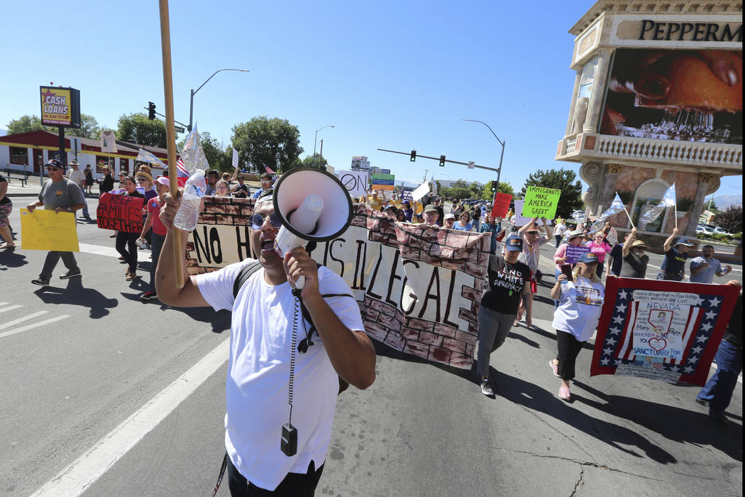 Protestors walk north on south Virginia street after demonstrating outside the Peppermill Resort-Casino in Reno during Attorney General Jeff Sessions delivers remarks on immigration to NASRO, a Sc ...