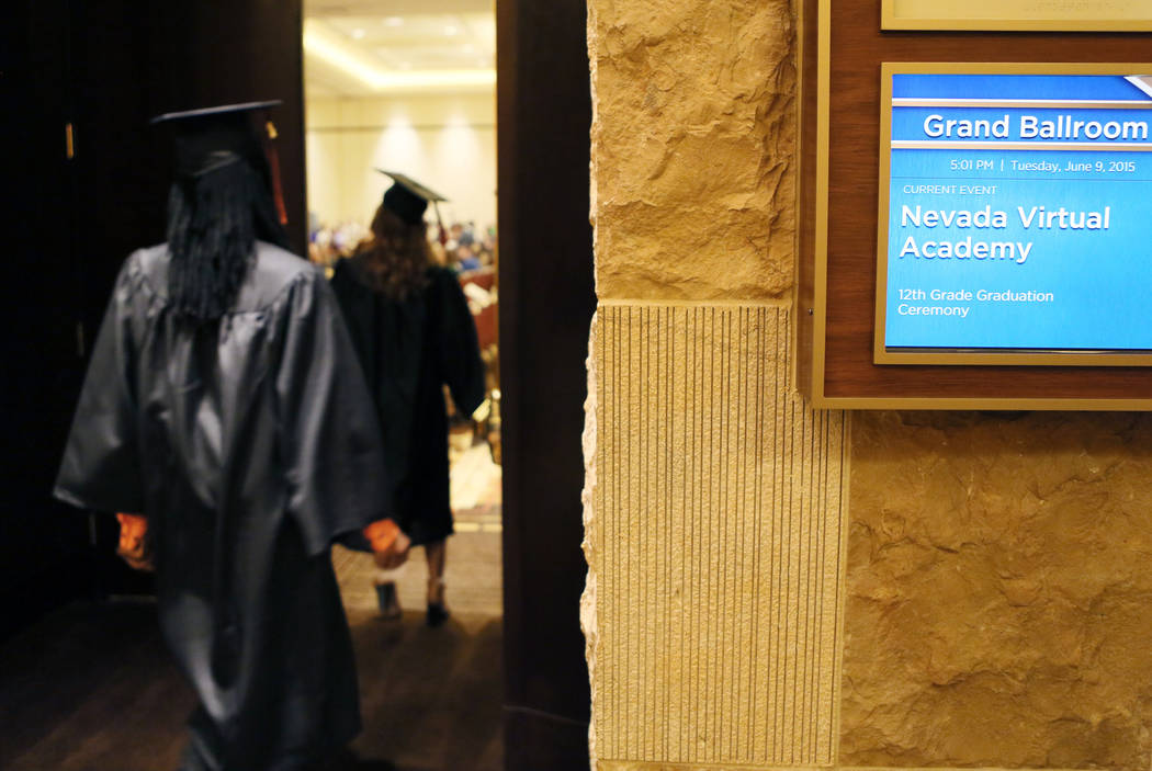 Nevada Virtual Academy high school graduates file into a ballroom at the start of the class of 2015 commencement ceremony at Aliante hotel-casino Tuesday, June 9, 2015, in North Las Vegas. More th ...