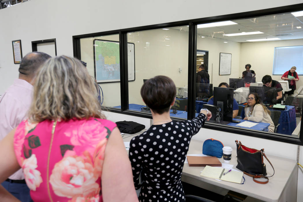 Observers watch Clark County election workers conduct a recount of the Democratic primary for the County Commission District E seat at election headquarters in Las Vegas Tuesday, June 26, 2018. K. ...
