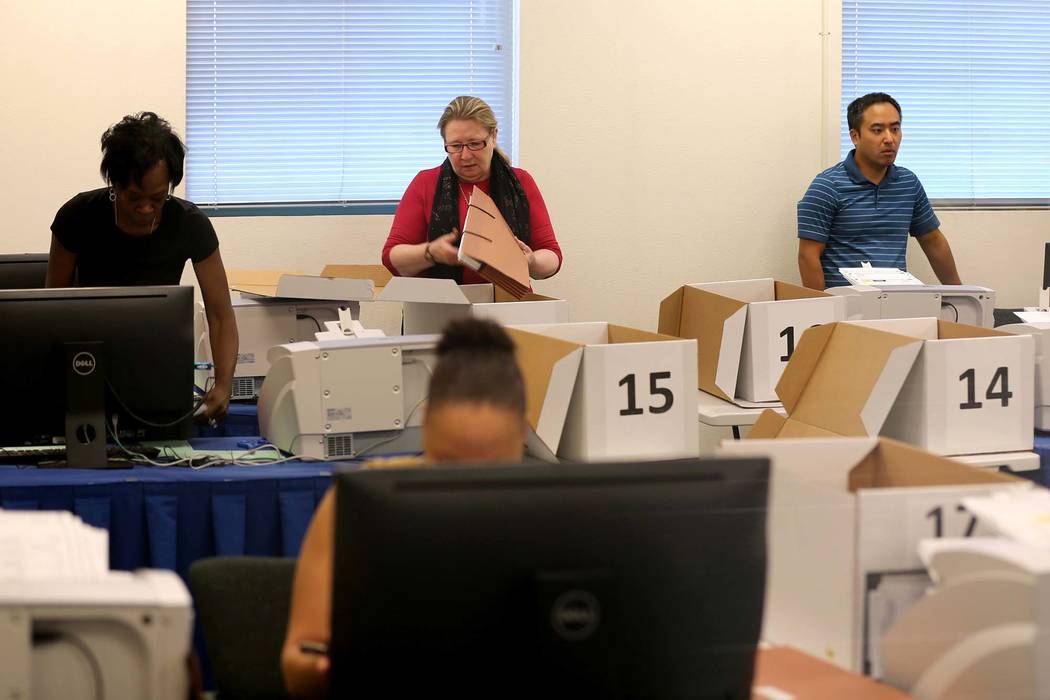 Clark County election workers count mail-in ballots during a recount of the Democratic primary for the County Commission District E seat at election headquarters in Las Vegas Tuesday, June 26, 201 ...