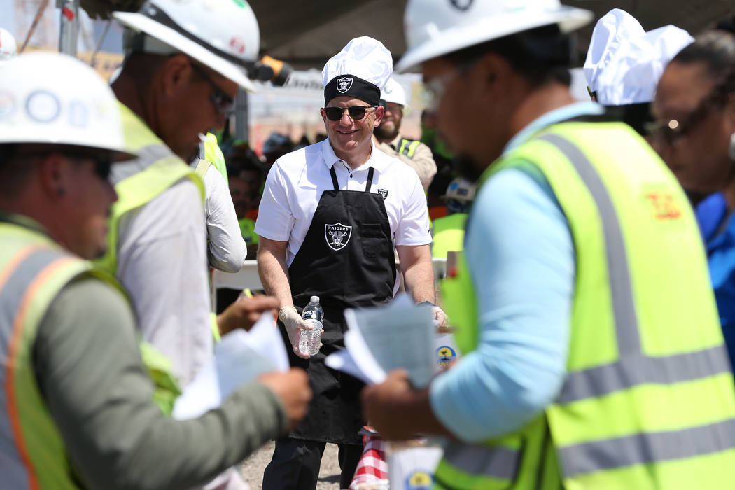 Oakland Raiders President Marc Badain hands out water during a barbecue for construction workers at the Raiders stadium site in Las Vegas, Thursday, June 28, 2018. Erik Verduzco Las Vegas Review-J ...