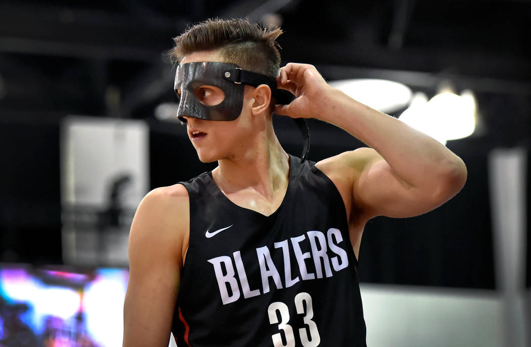 Portland Trail Blazer center Zach Collins adjusts his face mask during an NBA summer league basketball game against the Utah Jazz Saturday, July 7, 2018, in Las Vegas. David Becker/Las Vegas Revie ...