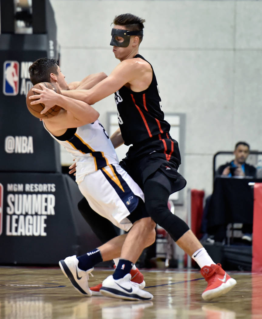 Portland Trail Blazer center Zach Collins, right, attempts to steal the ball from Utah Jazz guard Grayson Allen during an NBA summer league basketball game Saturday, July 7, 2018, in Las Vegas. Da ...