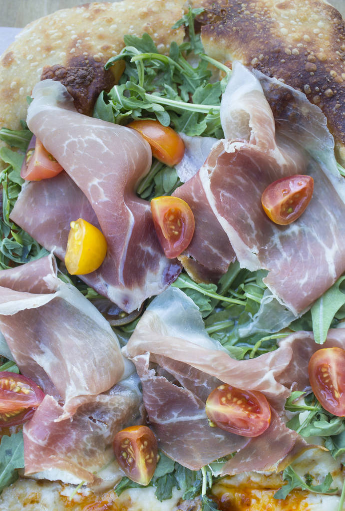 Vegas Meets Italy pizza with scamorza, mozzarella, ricotta, pistachio, dates, heirloom tomatoes, arugula, prosciutto and date cream at Pizzeria Monzœ on Monday, July 2, 2018, in Las Vegas. B ...