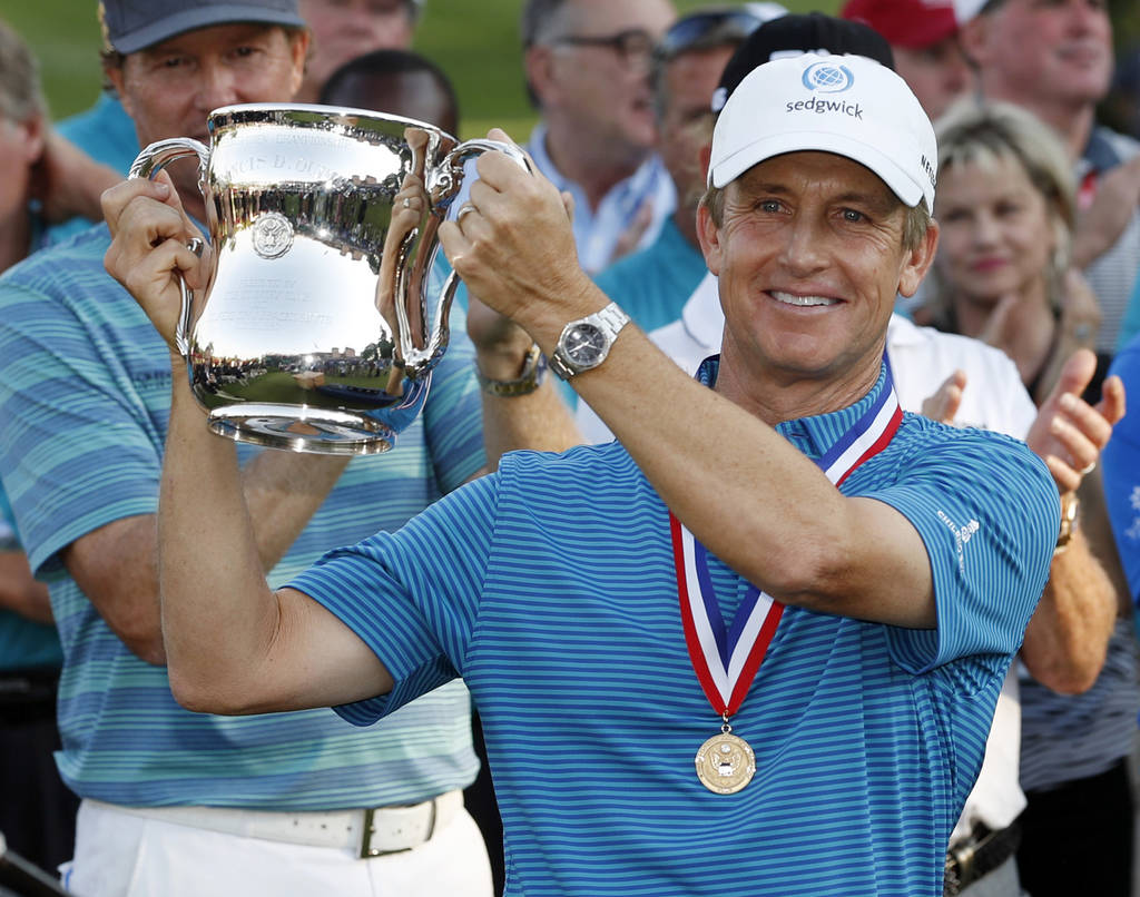 David Toms holds up the trophy after winning the U.S. Senior Open golf tournament at The Broadmoor, Sunday, July 1, 2018, in Colorado Springs, Colo. (AP Photo/David Zalubowski)