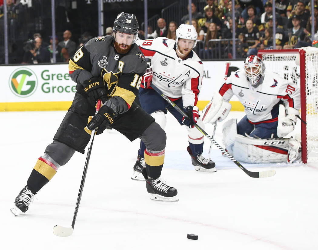 Golden Knights left wing James Neal (18) goes for the puck in front of Washington Capitals center Nicklas Backstrom (19) during the first period of Game 5 of the Stanley Cup Final at T-Mobile Aren ...