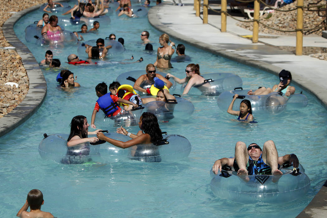 People float along the lazy river at Wet 'n' Wild Las Vegas water park in Las Vegas Saturday, June 8, 2013. Thousands of people flocked to the park to cool off during an Excessive Heat Warning in ...
