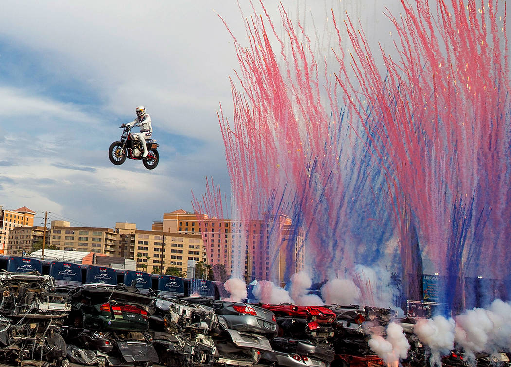 Daredevil Travis Pastrana jumps over 52 crushed cars on an Indian Scout FTR750 motorcycle during "Evel Live," a three-hour live tribute show to stuntman Evel Knievel, in a lot behind Pla ...