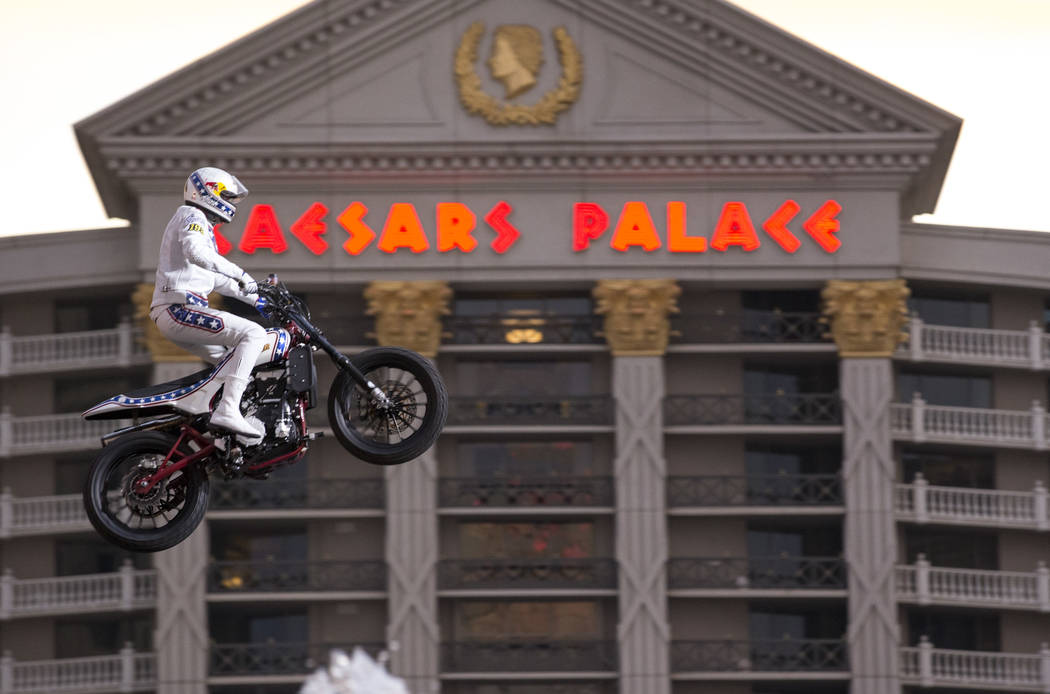Travis Pastrana jumps over the fountains at Caesars Palace on an Indian Scout FTR750 motorcycle during "Evel Live," a three-hour live tribute show to stuntman Evel Kneivel, in Las Vegas ...