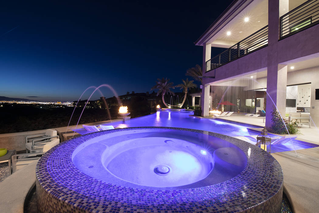 The home has a cascading waterfall leading to the spa area. (Sotheby’s International Realty)