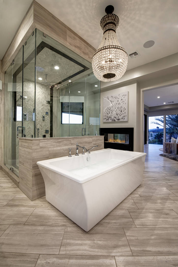 The master bath has a soaking tub and a fireplace. (Sotheby’s International Realty)
