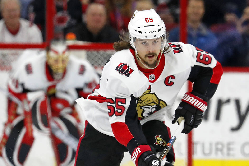 In this Jan. 30, 2018, file photo, Ottawa Senators' Erik Karlsson (65) moves the puck against the Carolina Hurricanes during the first period of an NHL hockey game, in Raleigh, N.C. (AP Photo/Karl ...
