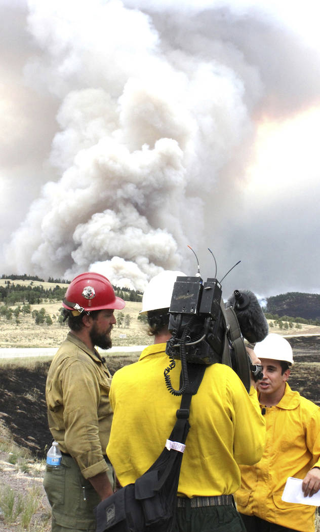 Smoke rises from the Spring Fire as it burns Tuesday, July 3, 2018, near Fort Garland, Colo. The growing wildfire destroyed more than 100 homes in the Colorado mountains, while other blazes across ...