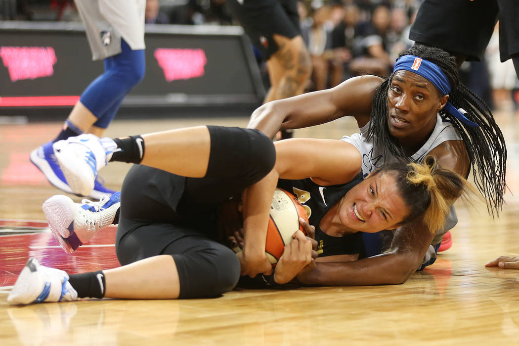 Las Vegas Aces guard Kayla McBride (21) grabs the ball from Minnesota Lynx players center Sylvia Fowles (34) and guard Tanisha Wright (30) at a WNBA basketball at the Mandalay Bay Events Center in ...