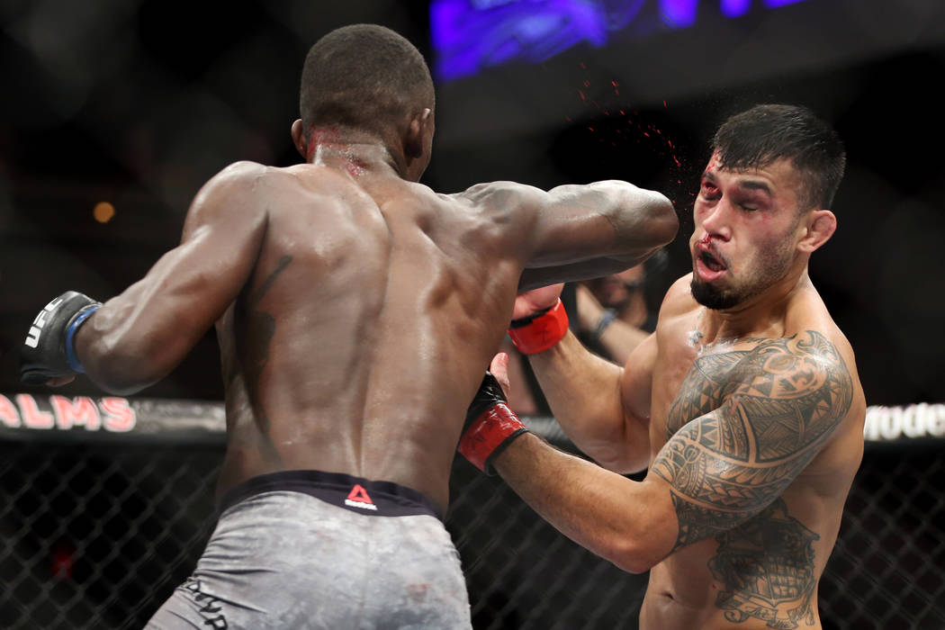 Unbeaten Israel Adesanya shines under spotlight of first UFC main event.