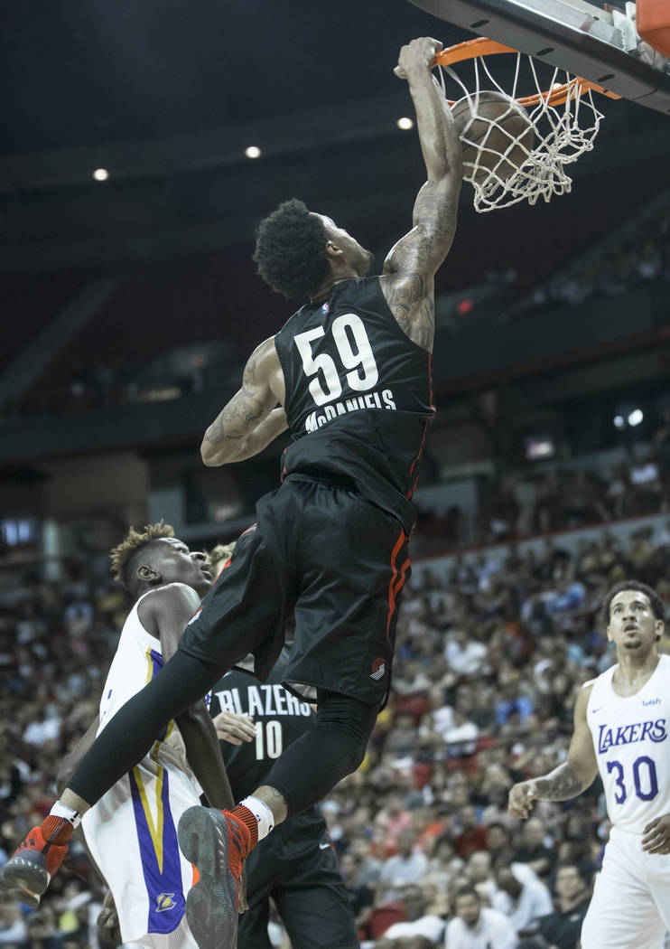 Portland Trail Blazers guard K.J. McDaniels (59) dunks over Los Angeles Lakers guard Isaac Bonga (17) in the fourth quarter during the NBA Summer League finals on Tuesday, July 17, 2018, at the Th ...