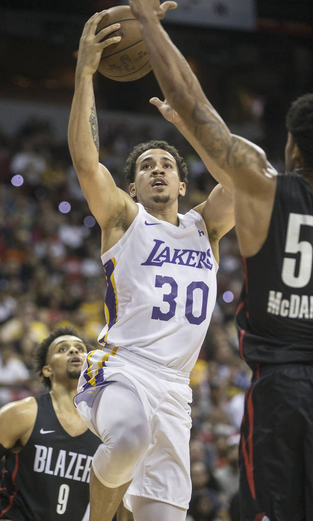 Los Angeles Lakers guard Jeffrey Carrol (30) drives past Portland Trail Blazers defenders Gary Trent Jr. (9) and K.J. McDaniels (59) in the third quarter during the NBA Summer League finals on Tue ...