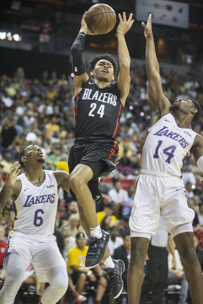 Portland Trail Blazers guard Anfernee Simons (24) drives past Los Angeles Lakers defenders Xavier Rathan-Mayes (6) and Malik Newman (14) in the second quarter during the NBA Summer League finals o ...