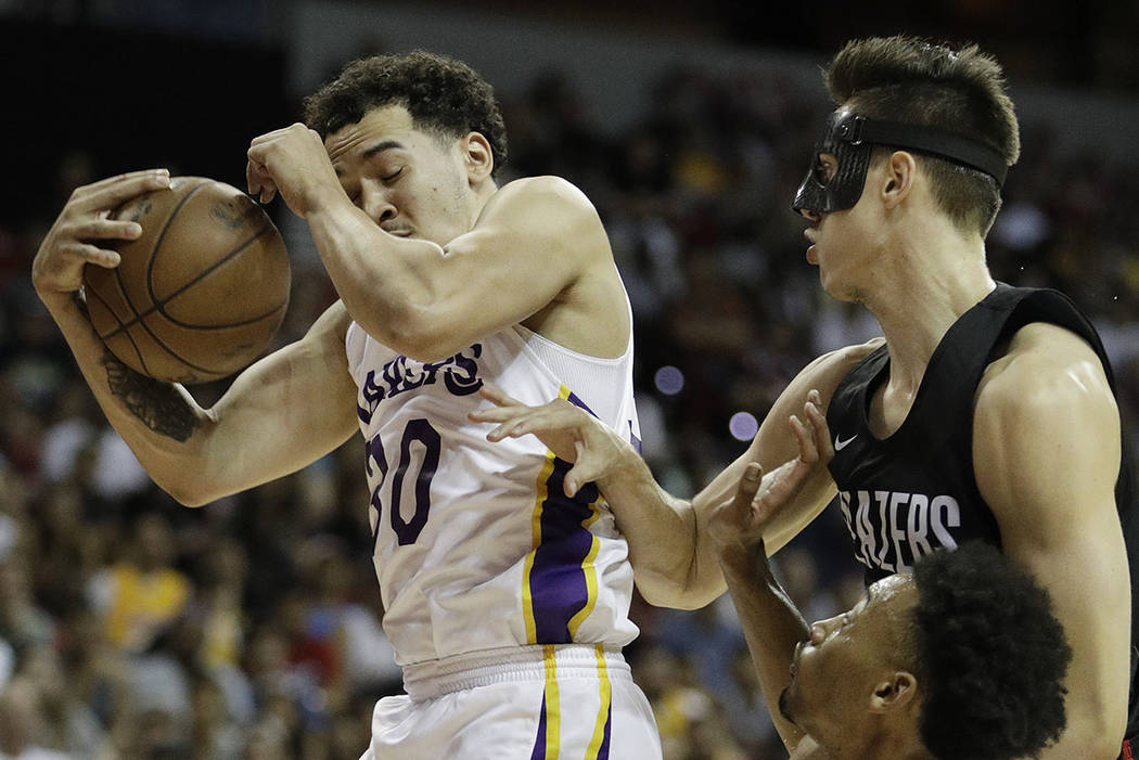 Portland Trail Blazers' Zach Collins, right, fouls Los Angeles Lakers' Jeffrey Carroll during the first half of an NBA summer league basketball game Tuesday, July 17, 2018, in Las Vegas. (AP Photo ...
