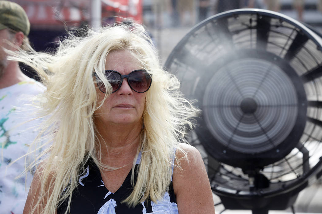 Janet Pleasants cools down in front of a giant fan at Evel Live, an event where Travis Pastrana attempted to exceed three of Evel Knievel's famous jumps in a lot behind Planet Hollywood hotel-reso ...
