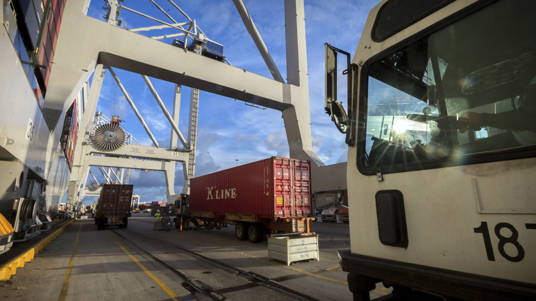 In this Thursday, July, 5, 2018 photo, Jockey trucks line up to under massive post-Panamax cranes to unload their 40-foot shipping container at the Port of Savannah in Savannah, Ga. The United Sta ...