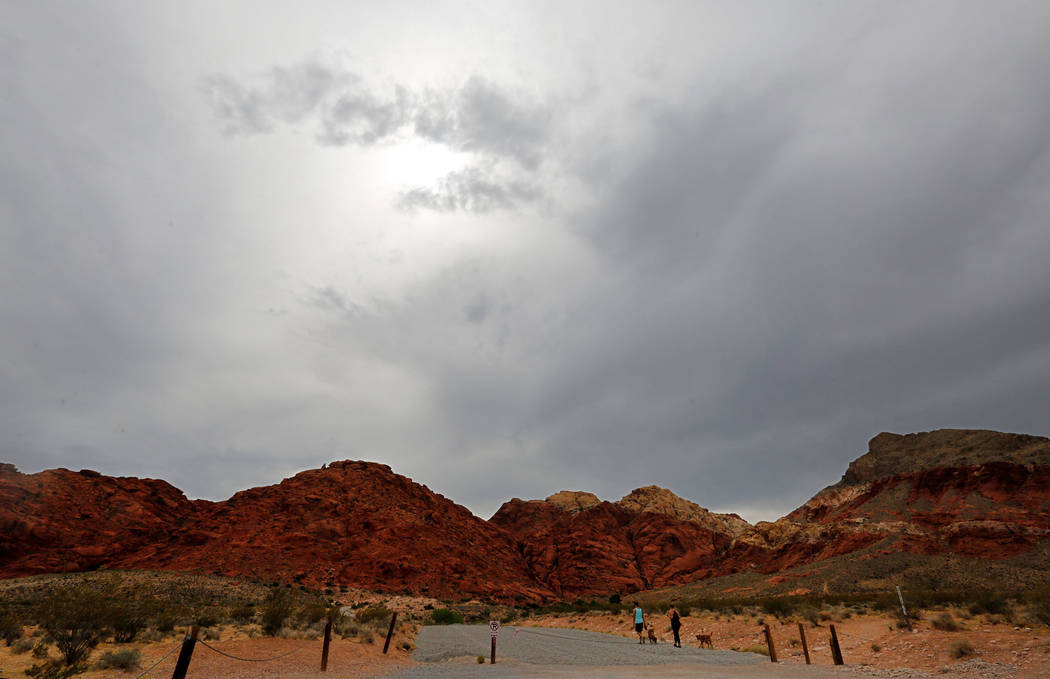Cloudy sky is seen at Red Rock Canyon in Las Vegas, Sunday, July 8, 2018, while a couple walks with their dogs. Chitose Suzuki Las Vegas Review-Journal @chitosephoto