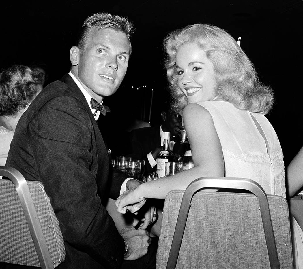 Actor Tab Hunter, left, with actress Tuesday Weld at a dinner