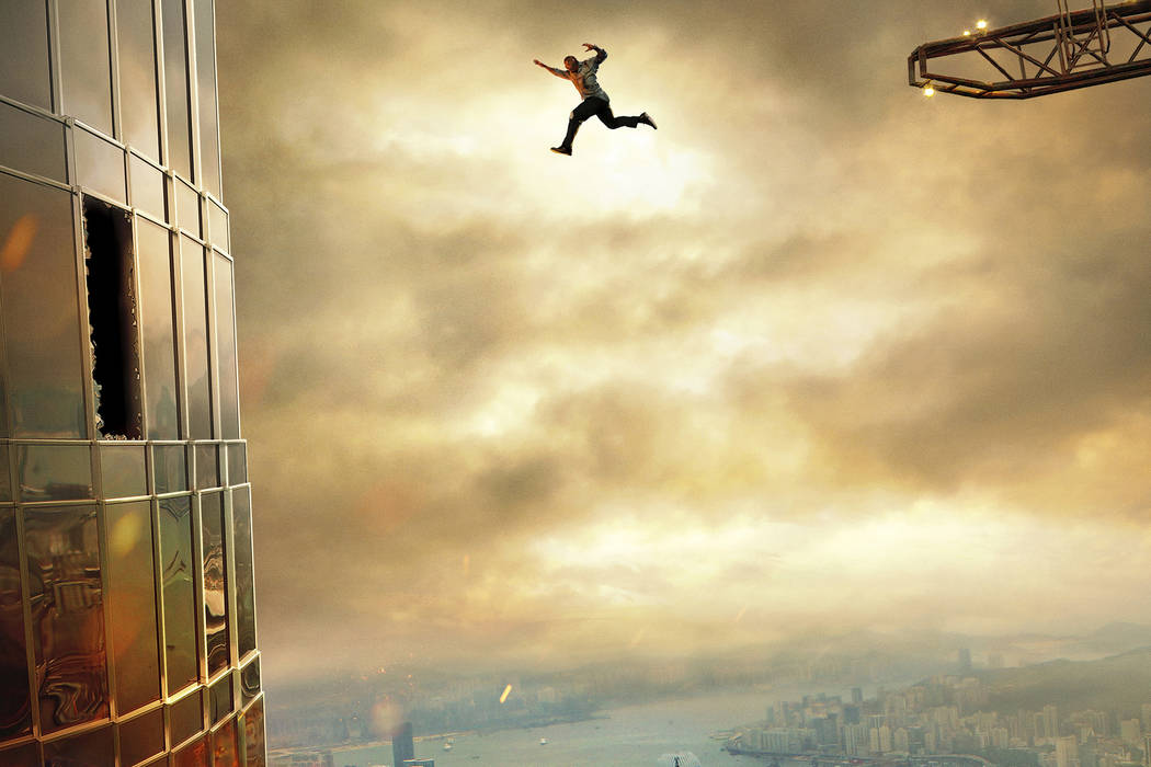 This image released by Universal Pictures shows Dwayne Johnson in a scene from "Skyscraper." (Universal Pictures via AP)