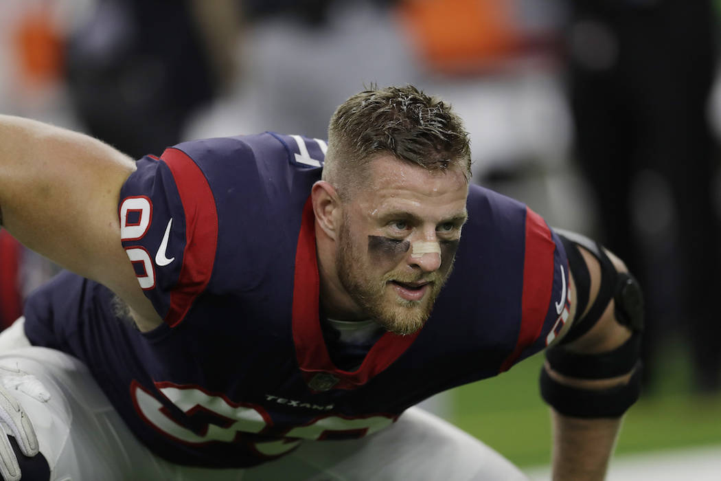 This Oct. 8, 2017 photo shows Houston Texans defensive end J.J. Watt (99) warming up before an NFL football game against the Kansas City Chiefs in Houston. Watt, along with Greg Olsen and Benjamin ...