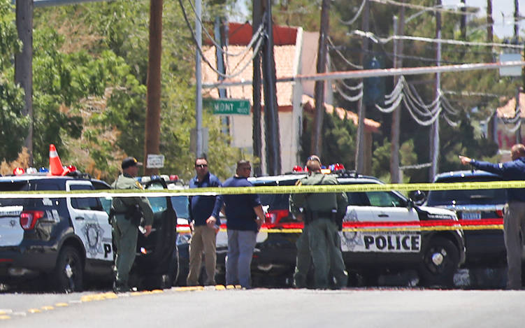 Members of the Metropolitan Police Department near Bruce and Ogden streets after an officer-involved shooting in Las Vegas, Wednesday, July 11, 2018. The school nearby, Hollingsworth Elementary, r ...