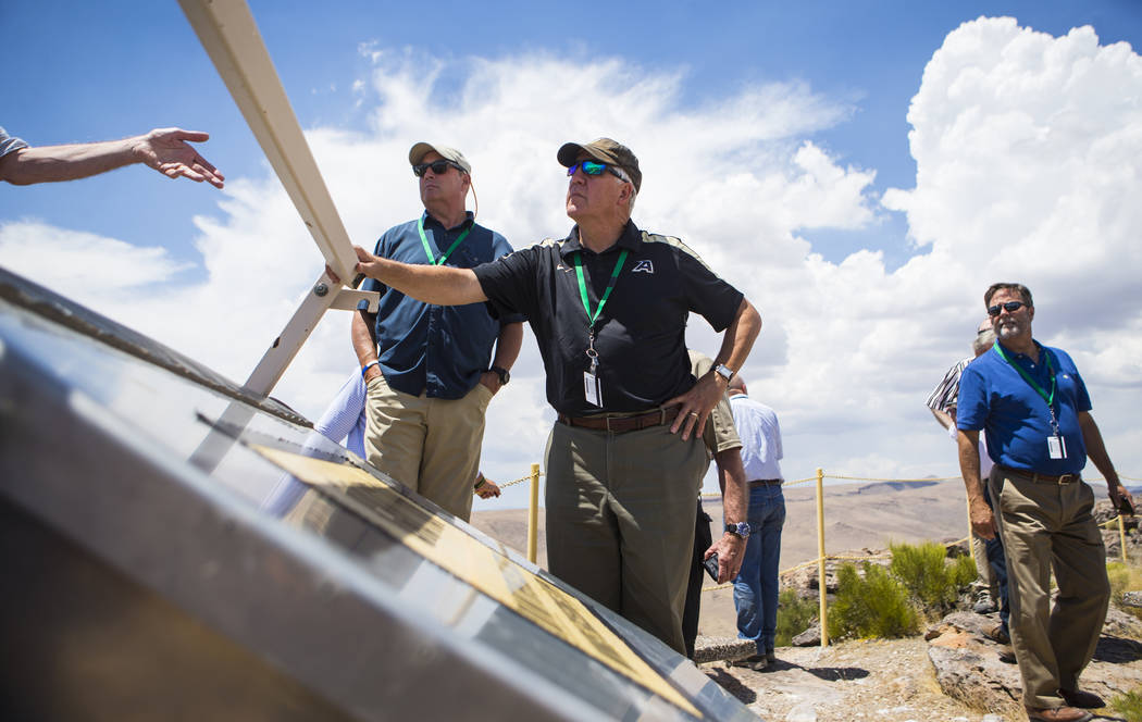 U.S. Rep. John Shimkus, R-Ill., center, listens to Wiilliam Boyle of the Department of Energy's Office of Nuclear Energy, not pictured, at the crest of Yucca Mountain during a congressional tour n ...