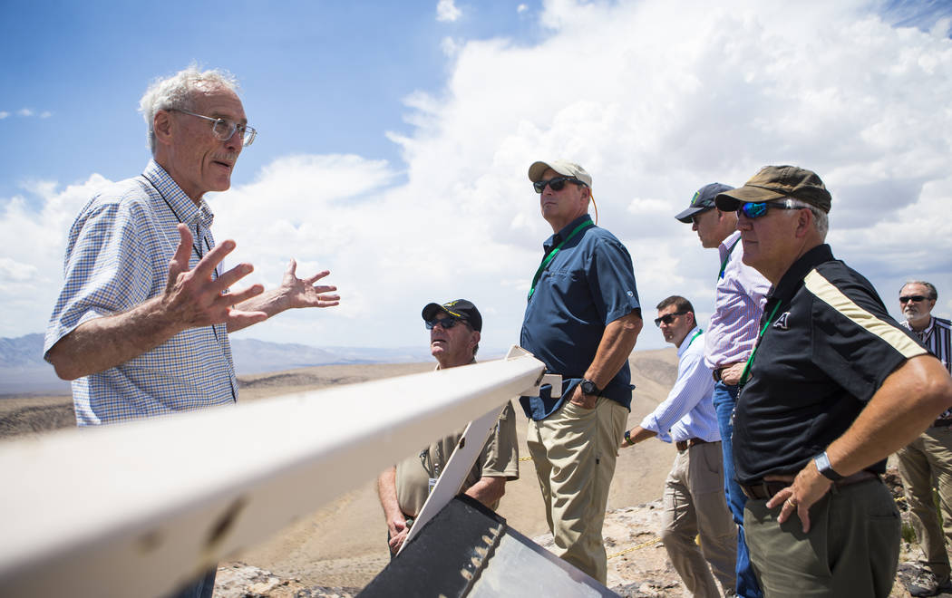 Wiilliam Boyle of the Department of Energy's Office of Nuclear Energy, left, speaks at the crest of Yucca Mountain during a congressional tour near Mercury on Saturday, July 14, 2018. Chase Steven ...