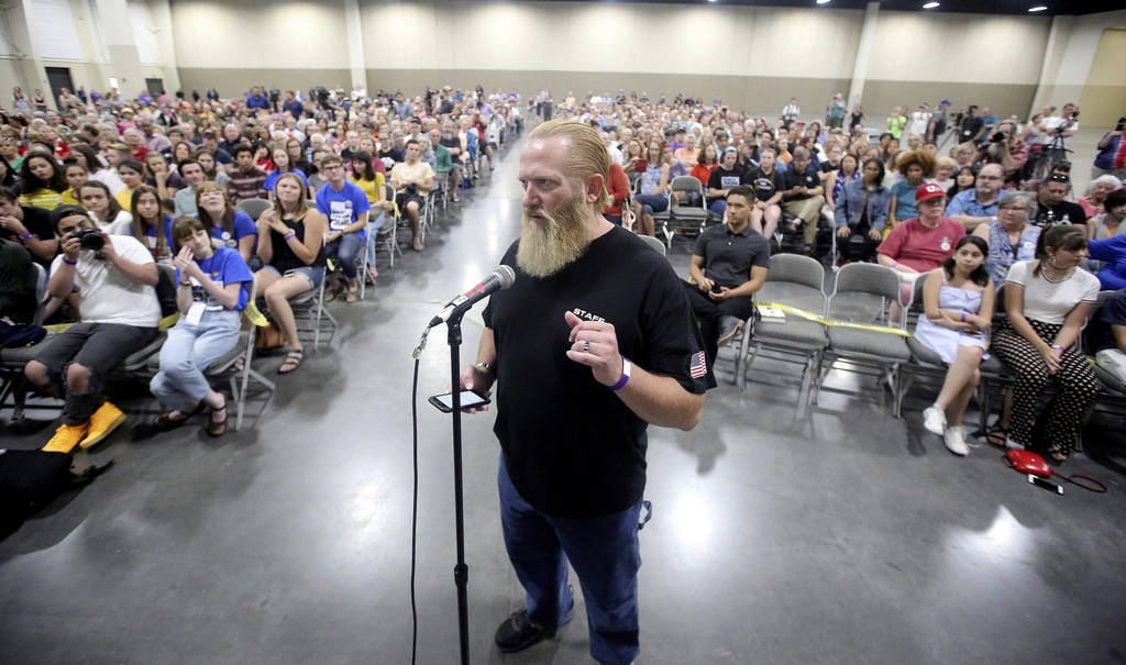 Sam Robinson, of Utah Gun Exchange, asks a question of student activists involved with the March for Our Lives movement at a town hall at the Mountain America Expo Center Saturday, July 14, 2018, ...