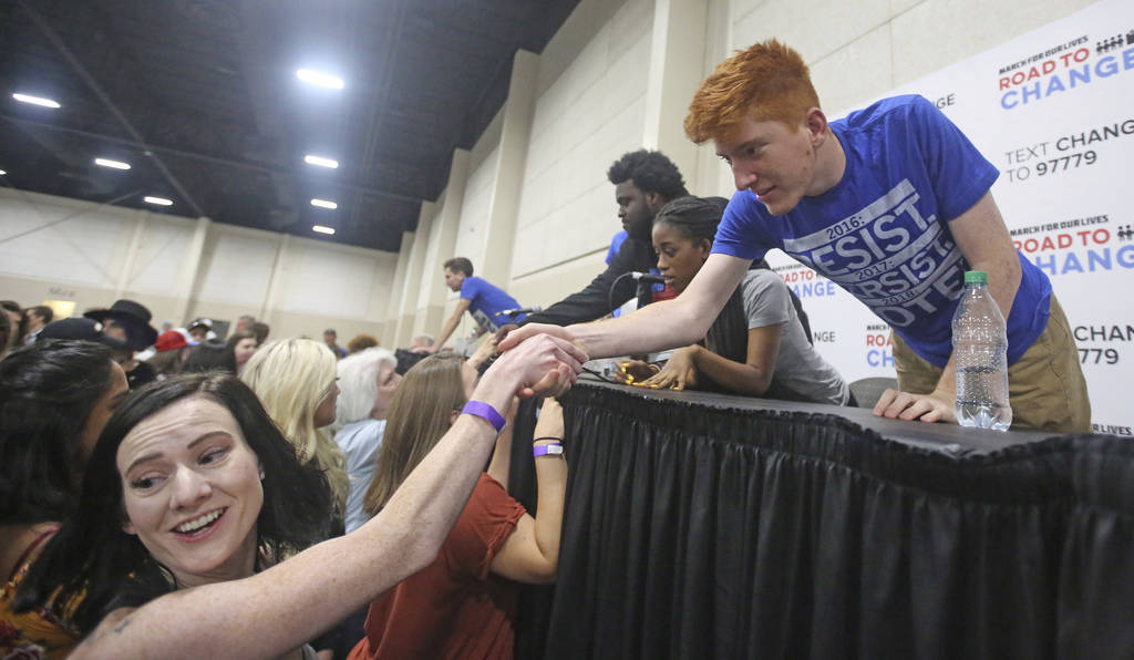 Ryan Deitsch, right, a student from Marjory Stoneman Douglas High School, receives a hand shake following a town hall at the Mountain America Expo Center Saturday, July 14, 2018, in Sandy, Utah. ( ...