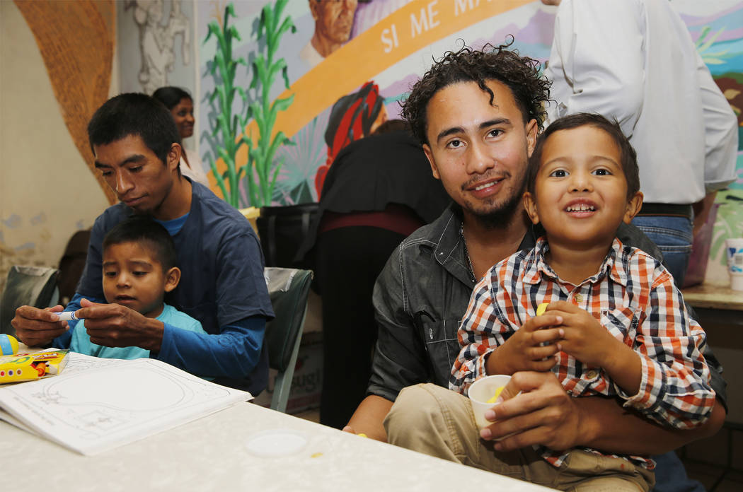 Roger Ardino, 24, and his son Roger Ardino Jr., 4, pose for a photo as they and Pablo Ortiz, 28, left, and his son Andres were speaking to members of the media during a news conference at the Annu ...