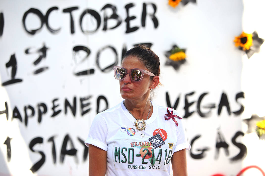 Patricia Oliver listens as her husband Manny Oliver address the crowd after he painted a mural at a Road to Change Voter Registration Walk at Sunset Park in Las Vegas, Monday, July 16, 2018. The e ...