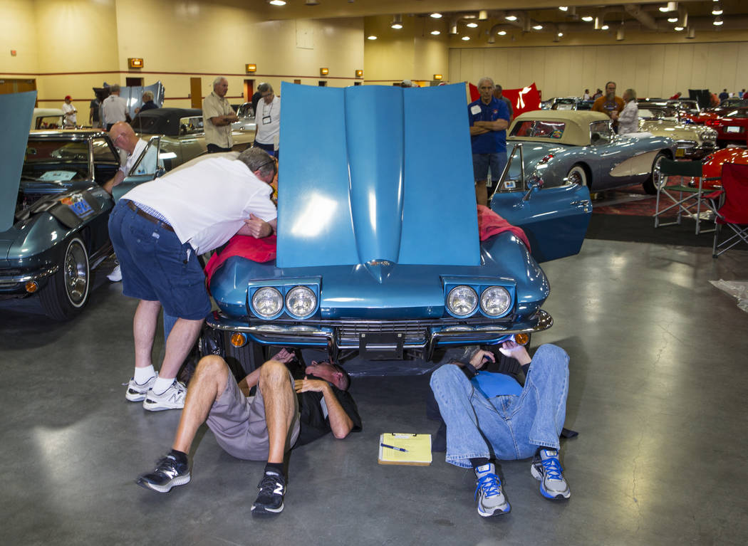 Attendees inspect a 1967 Corvette owned by Ray Geiger during the National Corvette Restorers Society convention at the South Point in Las Vegas on Tuesday, July 17, 2018. Chase Stevens Las Vegas R ...