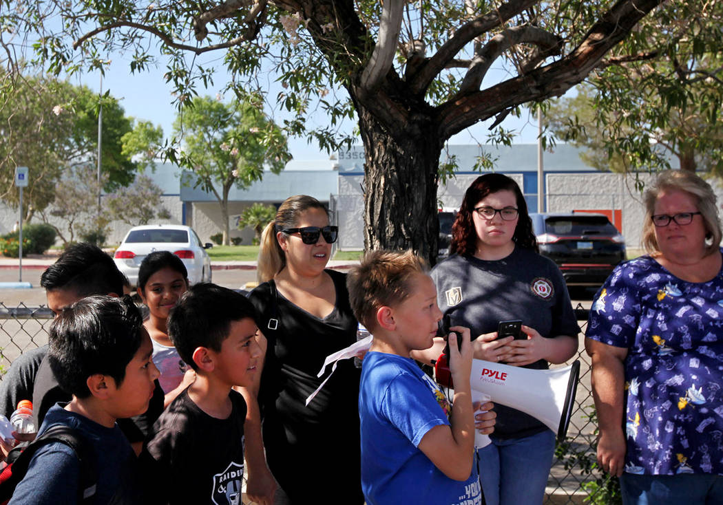 Ryan Brady, 10, speaks about grievances over CCSD budget cuts and other issues as students and parents listen during a town hall outside of Stanford Elementary School in Las Vegas, Wednesday, May ...