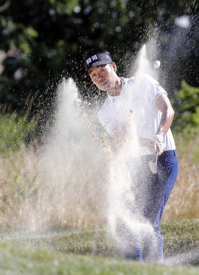 Kevin Na hits out of bunker on the 17th hole during the Military Tribute PGA Tour Golf Tournament at the Greenbrier in White Sulphur Springs, W. Va., Sunday, July 8, 2018. (AP Photo/Steve Helber)