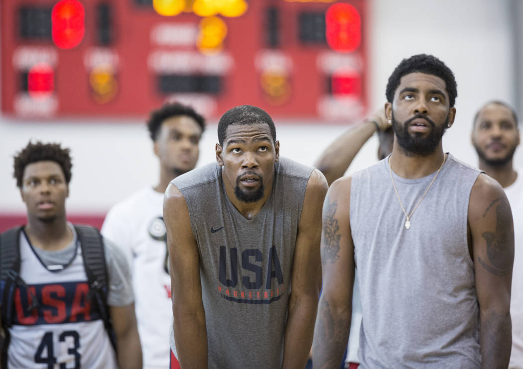 Golden State Warriors guard Kevin Durant (52) and Boston Celtics guard Kyrie Irving (37) watch practice during Team USA basketball's minicamp on Friday, July 27, 2018, at the Mendenhall Center, in ...