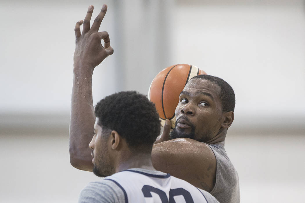 Golden State Warriors guard Kevin Durant (52) asks to confirm the score while being guarded by Oklahoma City Thunder forward Paul George (39) during Team USA basketball's minicamp on Friday, July ...