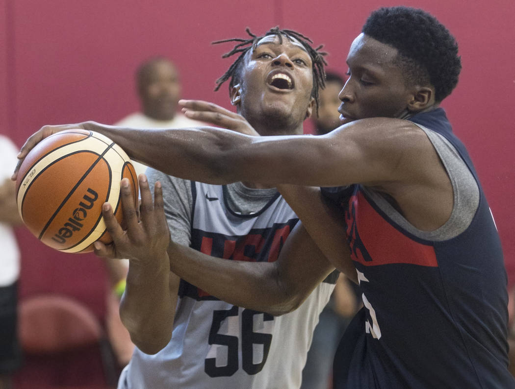 Indiana Pacers center Miles Turner (56) gets tied up with fellow Pacer Victor Oladipo (55) during Team USA basketball's minicamp on Friday, July 27, 2018, at the Mendenhall Center, in Las Vegas. B ...